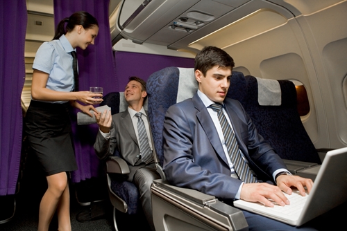 Businessman on plane working on computer