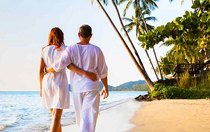 Newlyweds walking on beach