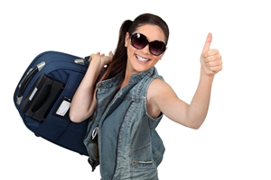 woman giving thumbs up while carrying on her luggage
